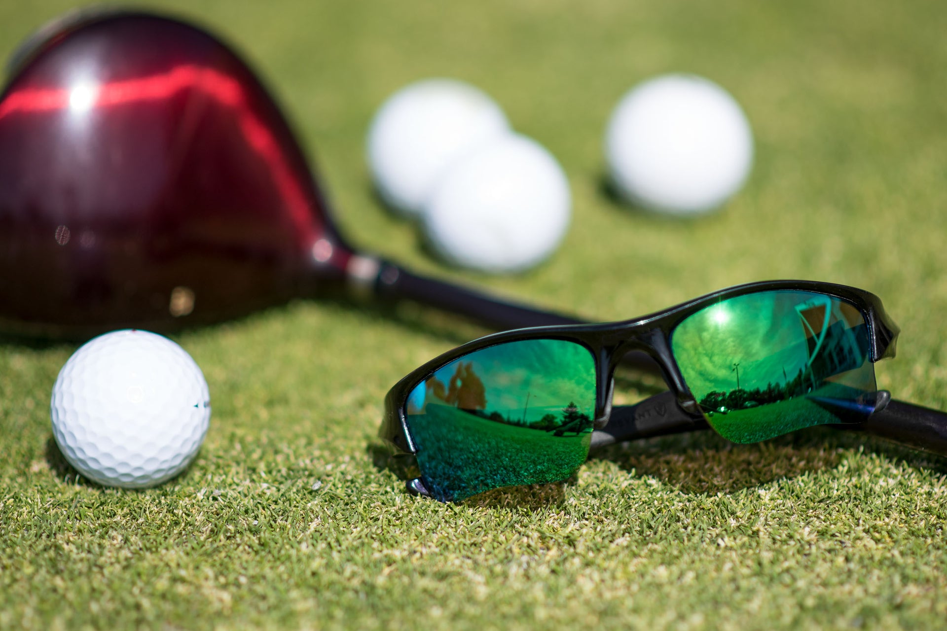 Golfer wearing G15 green tinted sunglasses on the course